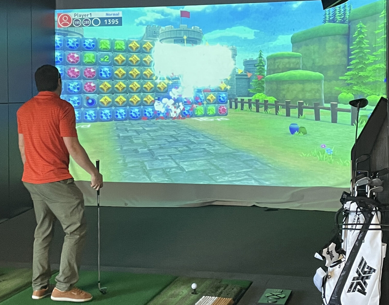 Golfers playing across the Pin Seeker simulator bays